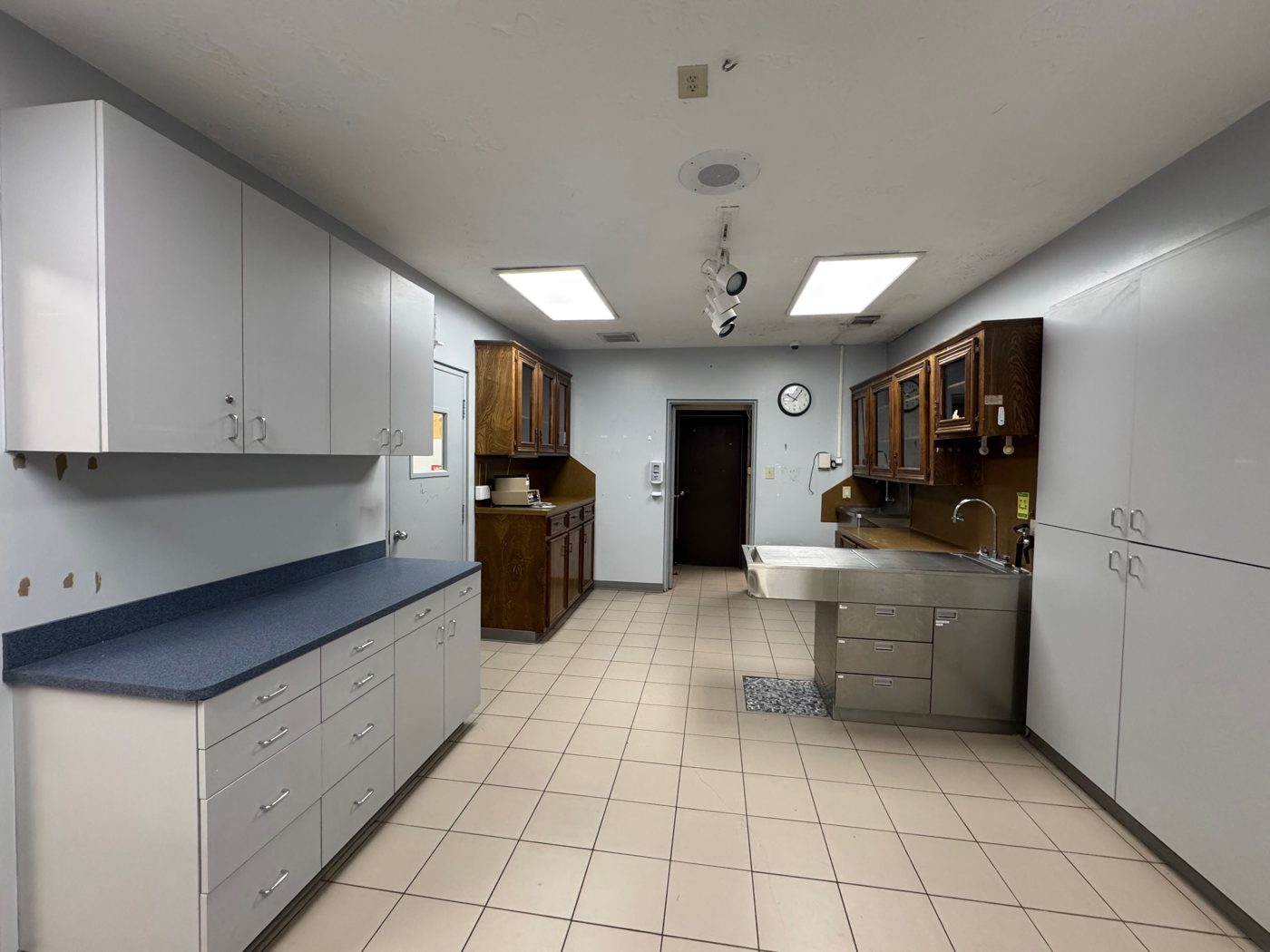 Central treatment area with built-in cabinetry and stainless wet tables